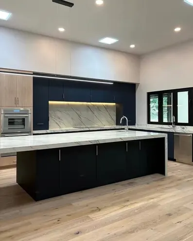 The same kitchen after our clean, with a clean island, counters and wood floor