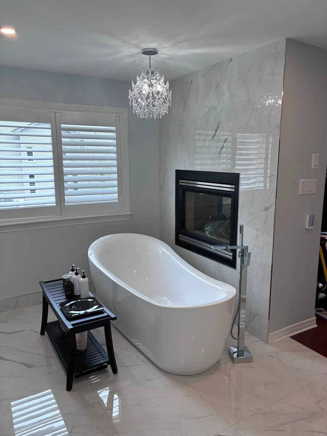 Freestanding tub and fireplace in a cleaned ensuite